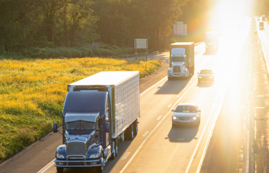 semi trucks and other traffic on sunny highway