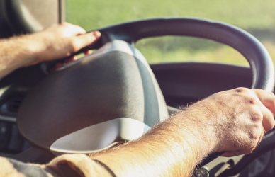 hands on the wheel of a semi truck