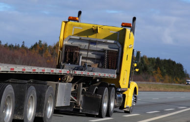yellow flat bed semi truck