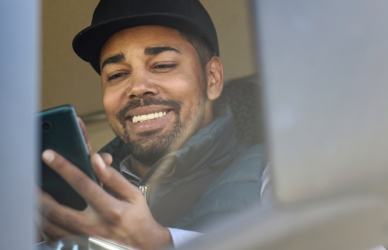 young trucker looking at phone