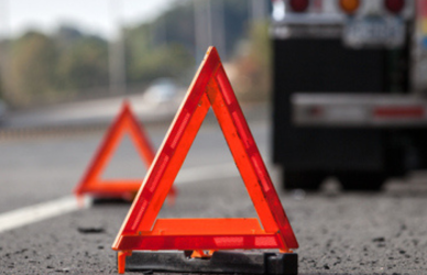 safety triangles on roadside with semi truck in background