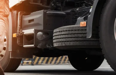 man in work boots walking towards semi truck