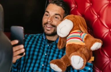 man in semi truck on facetiming while holding stuffed animal