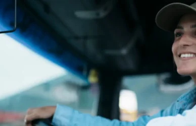 young woman driving semi truck