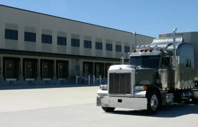semi truck parked behind loading docks