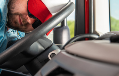 truck driver resting head on steering wheel