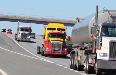 various types of semi trucks traveling on interstate highway