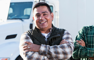 two men standing in front of semi truck