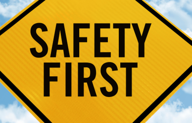 yellow road sign with the words "safety first" printed on it