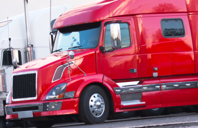 variety of semi trucks parked in a row