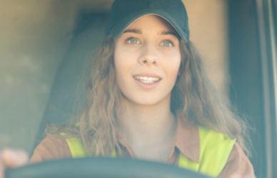 young woman driving semi truck