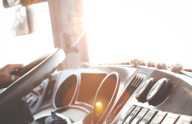 interior of semi truck cab with hand on wheel