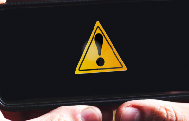 hands holding phone showing an alert notification