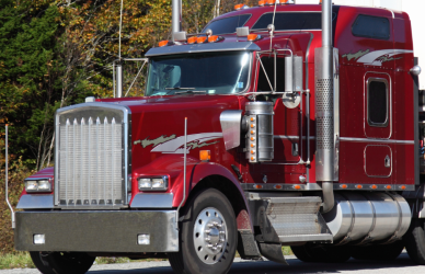 older red semi truck with white trailer