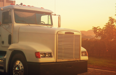 older white semi truck in sunset