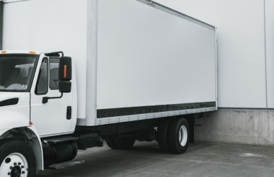 white semi truck backed up to loading dock