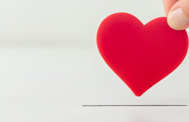 hand placing heart in slot