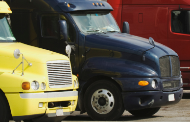 variety of colorful semi trucks parked in a row