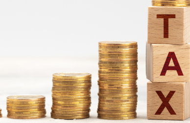 increasingly larger stacks of coins representing increasing taxes