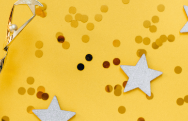 trophy and gold stars with confetti on a yellow background