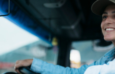woman in drivers seat of semi truck