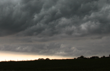 storm clouds over a silhouetted landscape