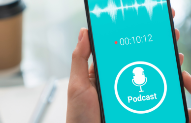 listening to podcast on phone with coffee cup in background