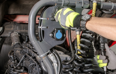 diesel technician working on diesel engine of semi truck