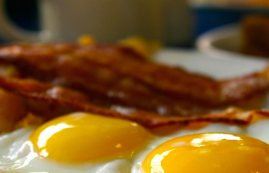 bacon and eggs on a plate at a diner