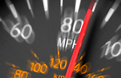 blurry speedometer with the needle indicating speed over 80mph