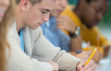 students in classroom at long table