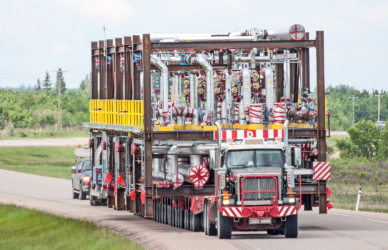 semi truck hauling oversized load on road