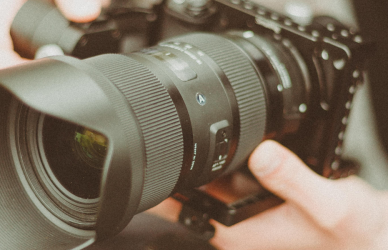Man holding camera with zoom lens