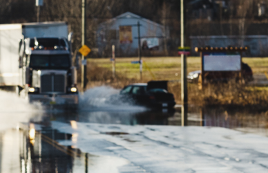 Semi truck driving through flood waters