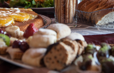 luncheon spread with a variety of food and drinks in stemmed glasses