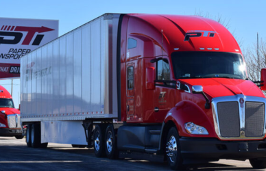 Paper Transport Semi truck in front of Paper Transport sign