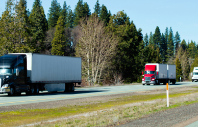 Semi trucks traveling on open highway national truck driver appreciation week