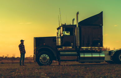 man standing next to semi truck silhoutted in sunset, veterans, cdl training
