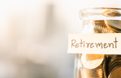 jar of coins marked "retirement" on blurred background , comprehensive retirement planning guide tailored for truck drivers.