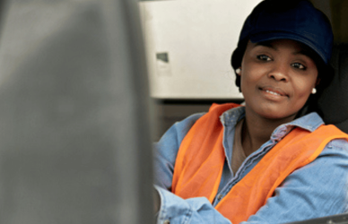 woman looking in sideview mirror of semi truck
