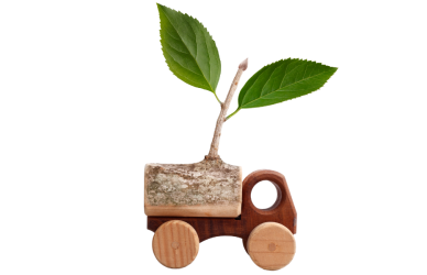 Wooden semi truck toy with green leafy plant growing out of truck bed