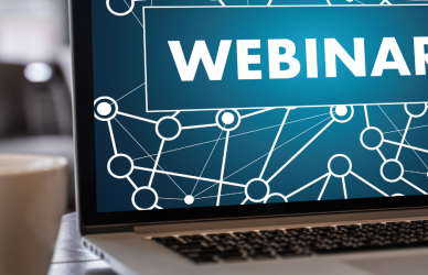 laptop opened to webinar with cup of coffee