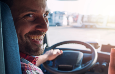 semi truck driver giving thumbs up