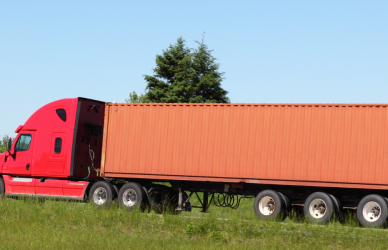red semi truck with orange trailer