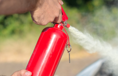 spraying fire extinguisher onto car