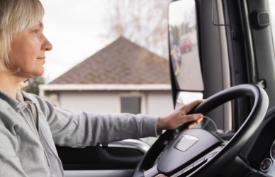 blonde woman driving semi truck