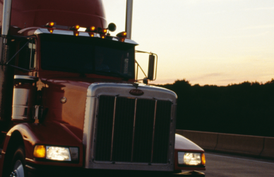 Semi truck on the road at sunset