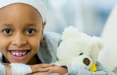 child in cancer ward with teddy bear