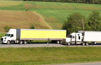 semi truck passing another semi truck