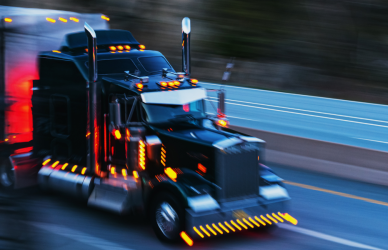 semi truck on road at dusk